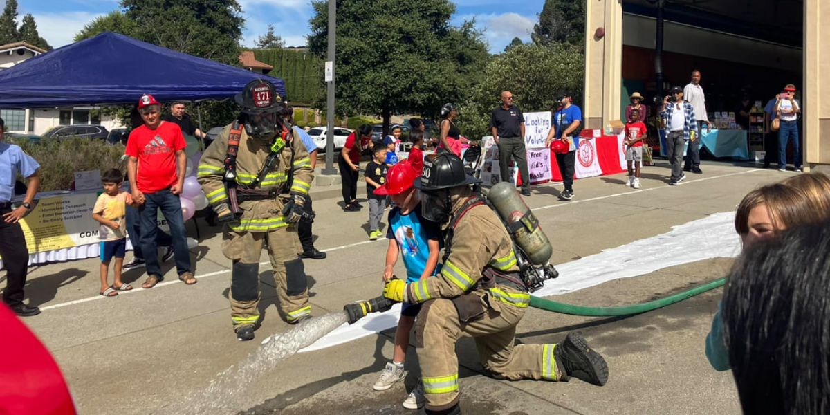 fire station 63 open house two fireman show how to use hose WCCFSC 20250118